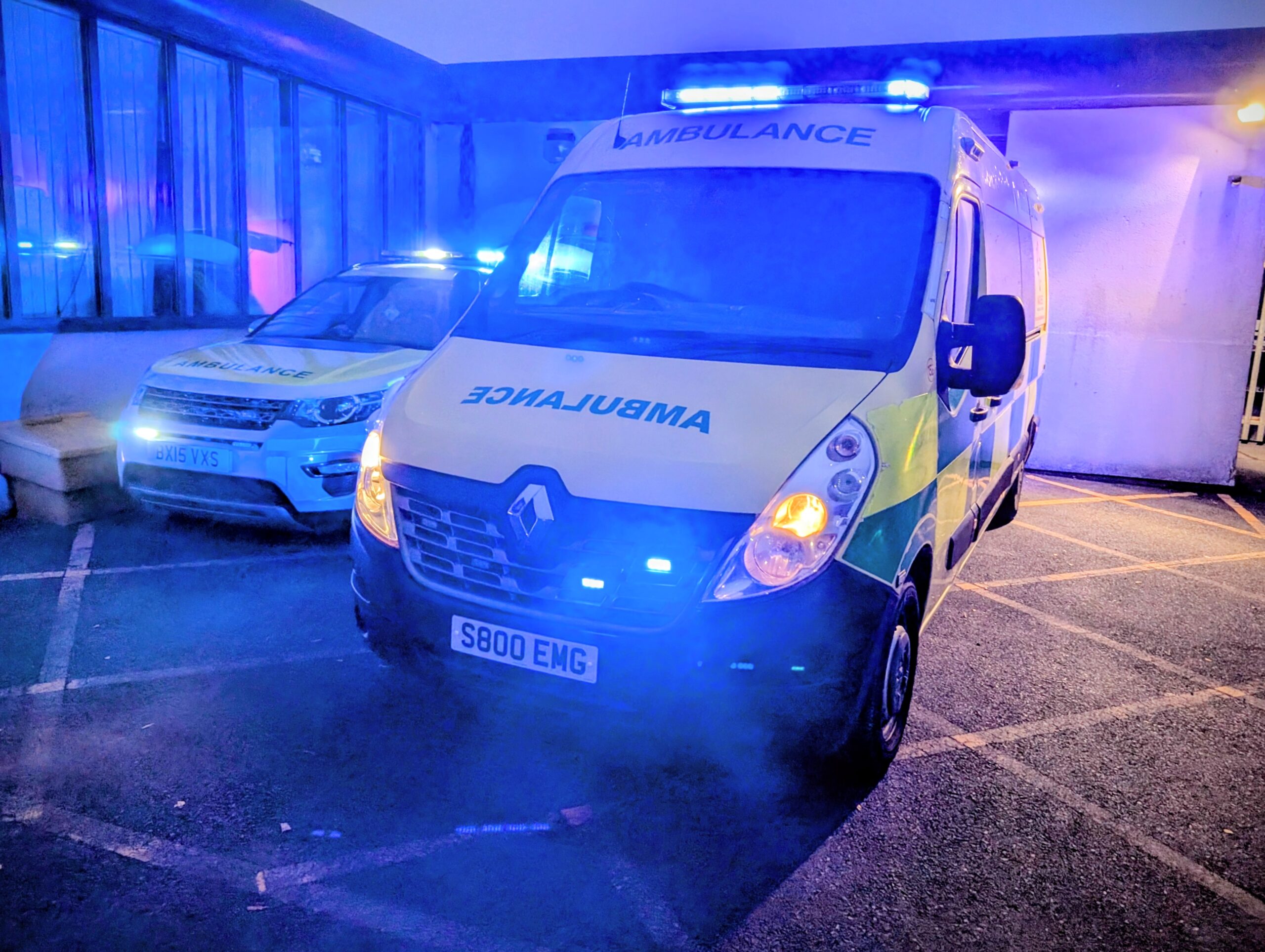 PXL_20251012_060838215~2 Marches Ambulance patient transport vehicle with blue lights at night